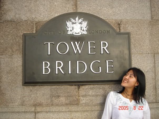 Lucy Lin beside the City of London Tower Bridge sign